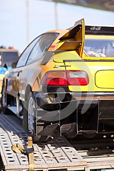 Rearlights of yellow sport car with black diffuser