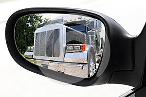 Rearview car driving mirror overtaking big truck