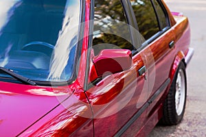 Rearview mirror on a red old car