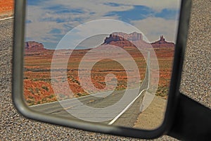 Rearview Mirror view of the road running through Monument Valley, Utah