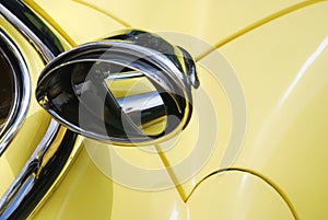 Rearview mirror on yellow car