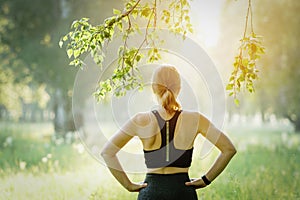 Rearview shot of a woman working out in the park