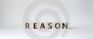 Reason symbol. Concept word Reason on wooden cubes. Beautiful white background. Business and Reason concept. Copy space