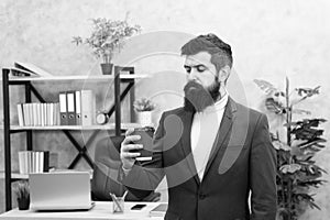Reasons coffee improves office culture. Man bearded manager businessman entrepreneur hold cup of coffee. Relaxed manager photo