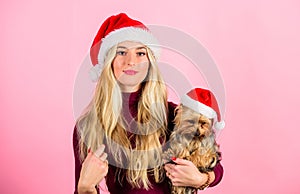 Reasons to love christmas with pets. Ways to have merry christmas with pets. Girl attractive blonde hold dog pet pink