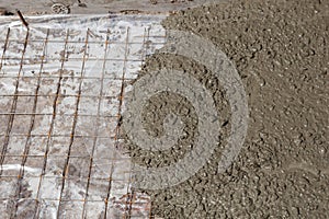 Rebar grids in a concrete floor during a pour.