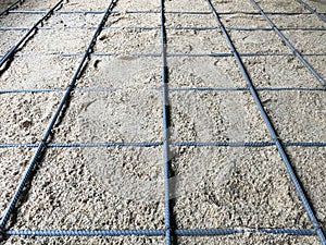 Rebar on sand for floor foundation at construction site