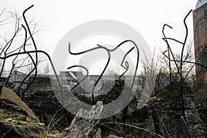 The rebar sticking up from piles of brick rubble, stone and concrete rubble against the sky in a haze - Remains of the destroyed