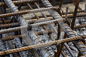 Rebar tie wire work at construction site. Steel bars reinforcing for reinforced concrete and building structures