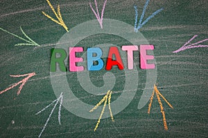 Rebate, business concept. Word and colored arrows on the green board