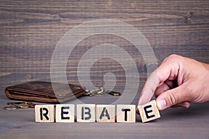 Rebate. Wooden letters on dark background