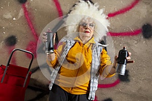 Rebel grandma graffiti artist against a wall