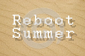 Reboot summer written on yellow sand background