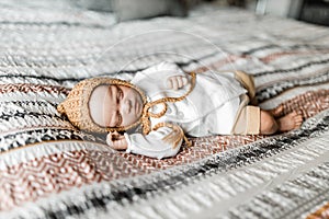 Reborn baby doll lying on a bed