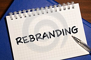 Rebranding written in a note. Rebrand marketing concept
