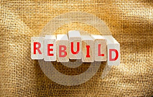 Rebuild and build symbol. The concept word Rebuild on wooden blocks. Beautiful canvas background, copy space. Business rebuild and