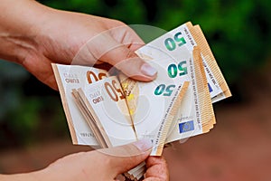Recalculation of euros by the hands of a banker.