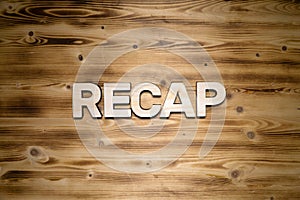 RECAP word made of wooden letters on wooden board photo