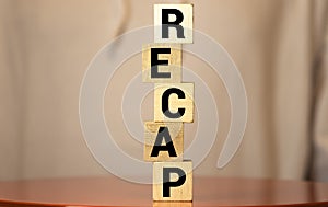 Recap word from wooden blocks on desk