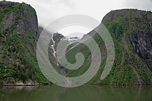 Receding glacier between two steep mountains in Tracy Arm Fjord, Alaska