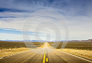 Receding road through desert photo