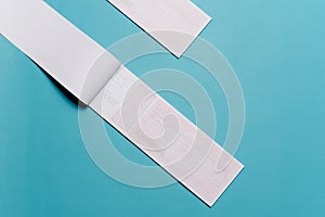 Receipt isolated over light blue paper