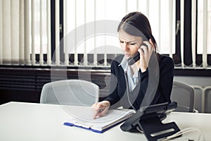 Receiving bad news phone call.Looking confused checking notes and paperwork.Manager solving mistake