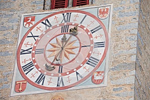 The recently restored clock and  sundial painted outside the bell tower of the church of the town