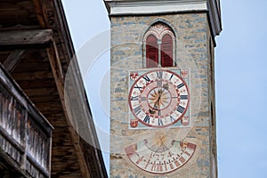 The recently restored clock and sundial painted outside the bell towerd sundial painted outside the bell tower of the church of