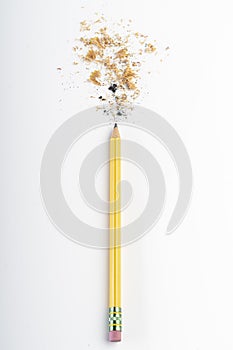 Recently sharpened pencil with wood shavings and mine on a white table