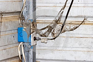 Receptacle and wires covered in webs