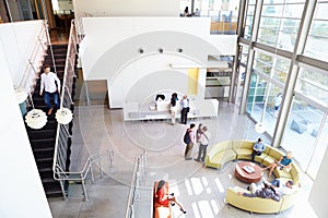 Reception Area Of Modern Office Building With People