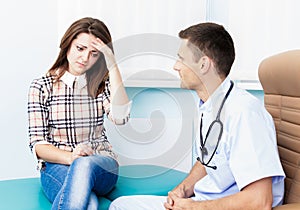 At a reception at the doctor Female patient holding his head. Visit a doctor in the hospital sick woman. Migraine