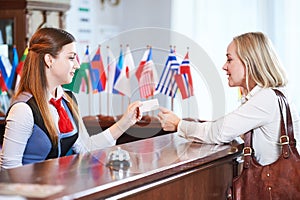 Reception front desk at hotel. Worker and guest