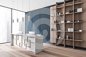 Reception interior desk with computers and shelf with books, window