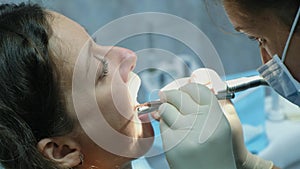 At the reception of an orthodontist. Dentist is treating the patients teeth. Visit to the stomatologist