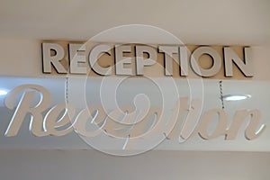 Reception sign suspended from the ceiling in the hotel building