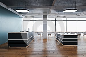 Reception table with computers on loft interior with city view
