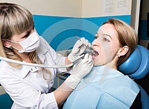 The reception was at the female dentist. Doctor examines the oral cavity on tooth decay. Caries protection. doctor puts