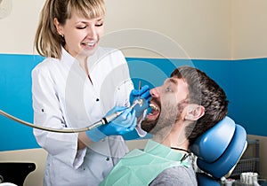 The reception was at the female dentist. Doctor examines the oral cavity on tooth decay. Caries protection. doctor puts