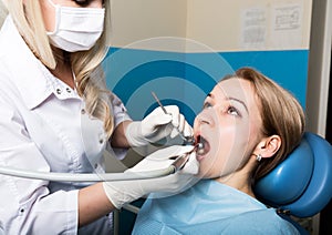 The reception was at the female dentist. Doctor examines the oral cavity on tooth decay. Caries protection. doctor puts