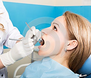 The reception was at the female dentist. Doctor examines the oral cavity on tooth decay. Caries protection. Tooth decay