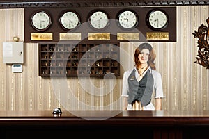 Receptionist at counter desk of modern hotel