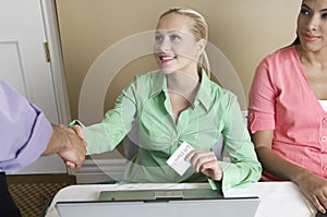 Receptionist Distributing Name Tags