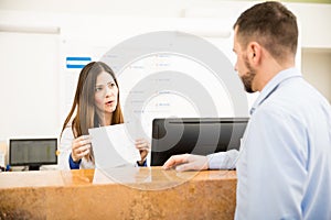 Receptionist explaining services to patient