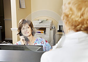 Receptionist Greets Patient photo