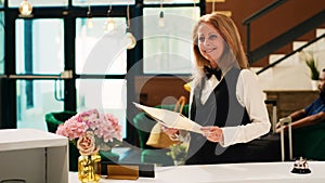 Receptionist looking at reservations photo