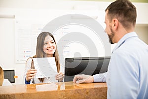 Receptionist showing services and costs