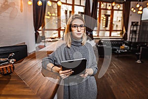 Receptionist standing at reception counter in office