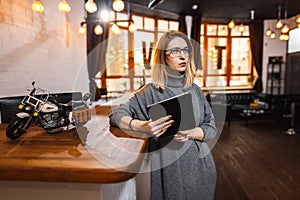 Receptionist standing at reception counter in office
